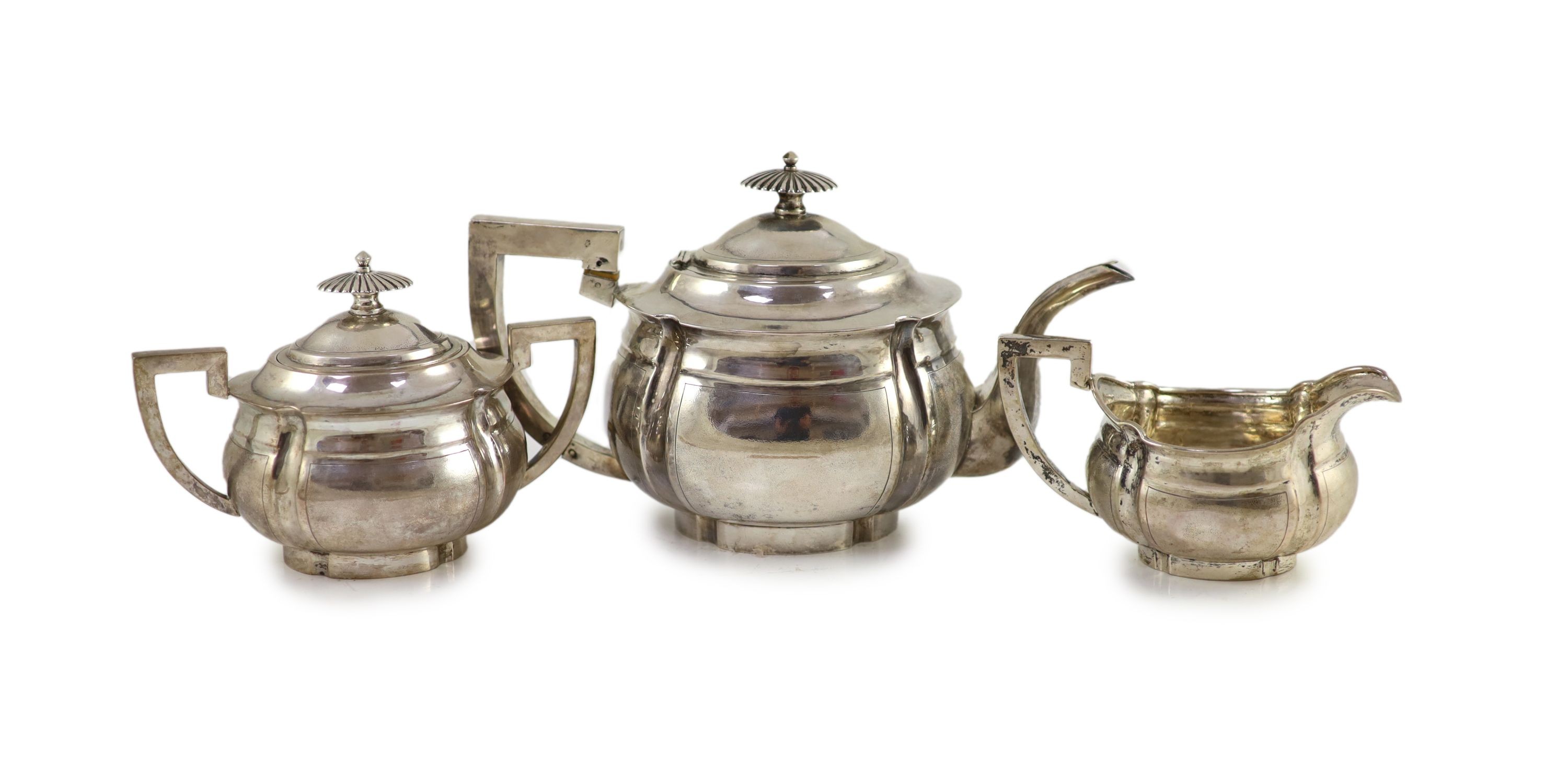 An early 20th century Chinese white metal three piece tea set by Zee Wo